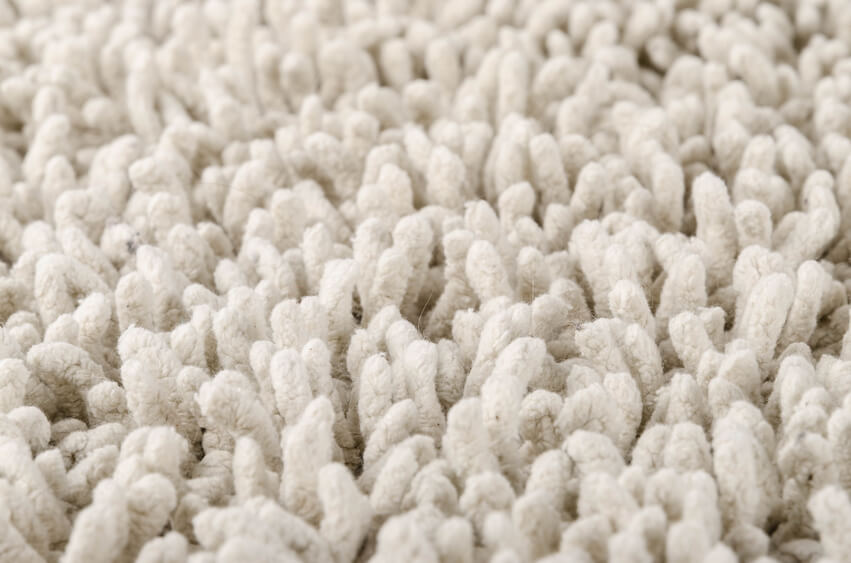 White carpet Close up of a white fluffy new and clean carpet.