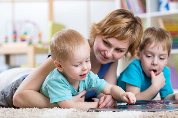 Image of a mother and children reading on the carpet after taking advantage of fast carpet cleaning in West Valley City