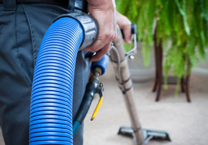 Steam Cleaning Carpets Man cleaning carpets in home